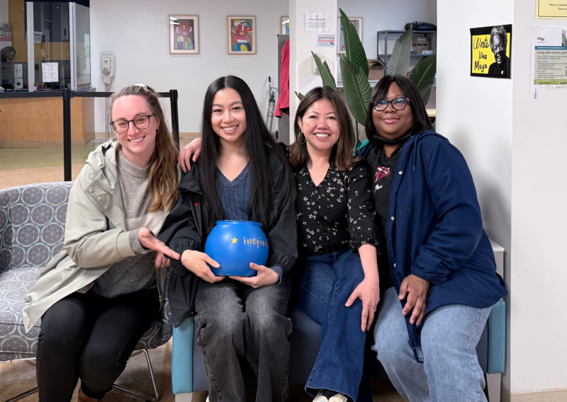 Pictured are Carolyn Ta and 3 coworkers seated on a sofa at the INSPIRE Clinic.